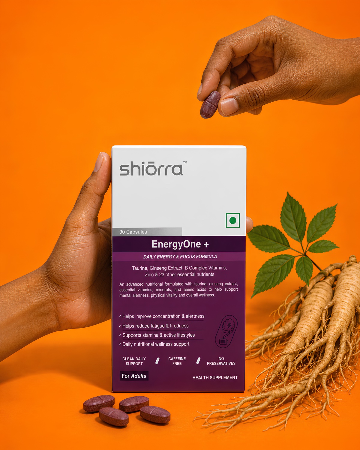 Two hands offering a Shiōrra Advanced EnergyOne+ capsule beside the pack and ginseng root on an orange backdrop
